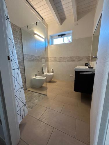 a bathroom with a toilet and a sink and a shower at Casetta rossa in Lesignano deʼ Bagni