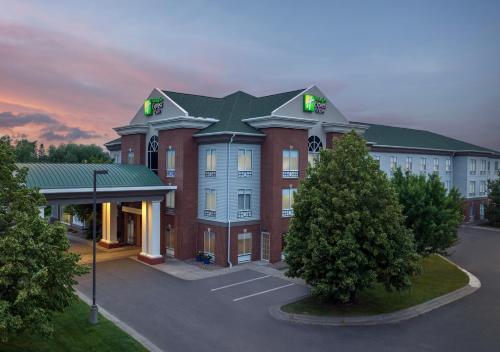 a large red brick building with a green roof at Holiday Inn Express & Suites Superior by IHG in Superior