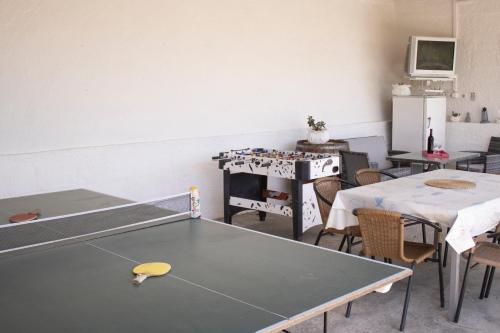 a room with a ping pong table and chairs at Apartment Nikola Škarica 1 in Duće