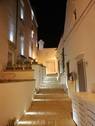 a stairway leading up to a building at night at Zahra Superior Suite with private pool in Sannicola