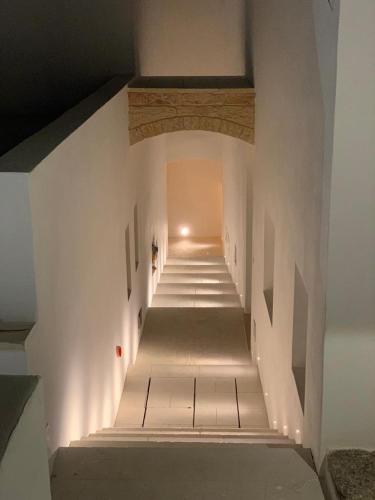 a long hallway with stairs in a building at Zahra Superior Suite with private pool in Sannicola