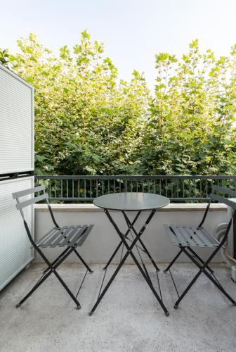 a table and two chairs on a balcony at Frinichou 18 by Athens Concept Residences in Athens