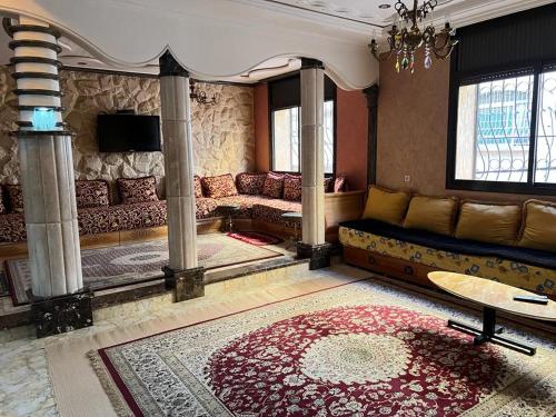 a living room with a couch and a table at "Pearl in Middle Atlas" in Azrou