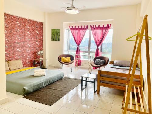 a bedroom with a bed and chairs and a brick wall at 3BR 8PAX KL City Centre KLCC View Ampang Boulevard Condo in Ampang