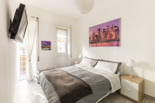 a bedroom with a bed and a flat screen tv at Nicla's Home in Rome