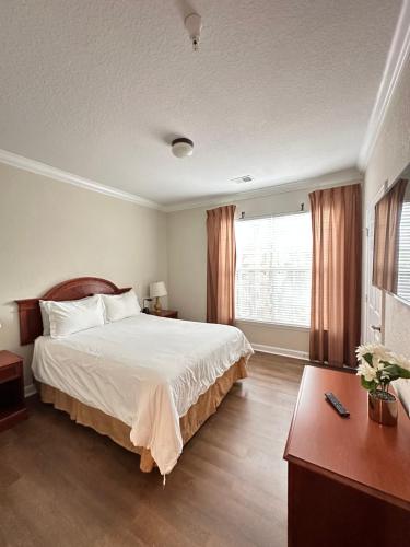 a bedroom with a large bed and a window at Gone 2 Florida Vacation Homes in Orlando