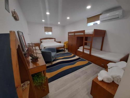a room with two bunk beds and a couch at Casa da Varanda in Carreço