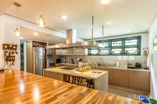 a kitchen with a wooden counter top in a room at Casa de Campo in Atibaia
