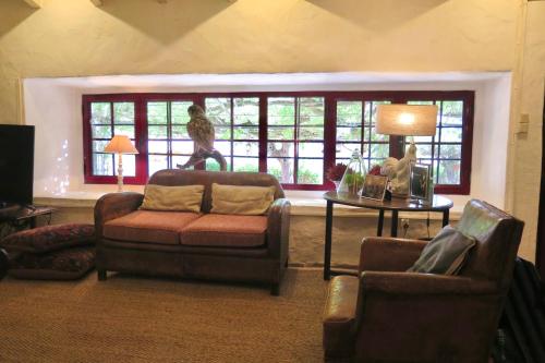 a living room with a couch and chairs and a window at Herdade da Madalena in Sousel