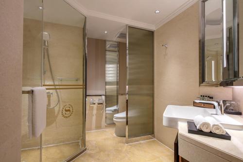 a bathroom with a shower and a sink and a toilet at Sheraton Nanjing Kingsley Hotel & Towers in Nanjing