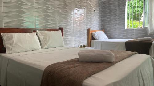 Un pat sau paturi într-o cameră la Hospedaria Além das Trilhas