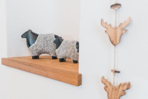 two elephants on a wooden shelf next to a wall at Felbermayer Appartements in Gaschurn