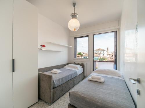 Duas camas num quarto com uma janela em Le Terrazze em Veneza