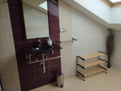 a bathroom with a sink and a mirror at Ático Vista Alegre in Lerma