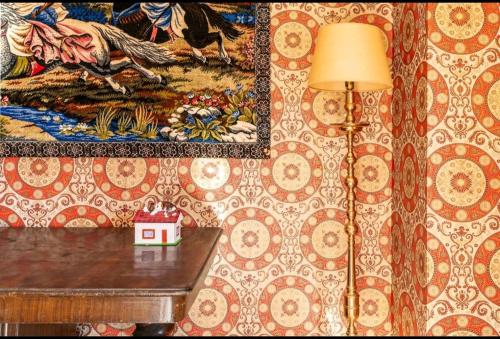 a lamp on a table in a room with a wall at La Solariega in Padul