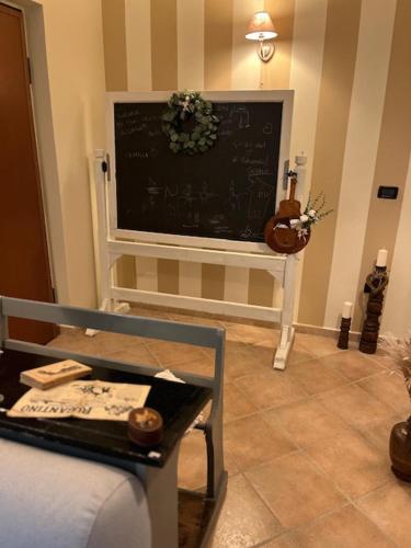 a living room with a chalkboard on the wall at La Casina di Sandro in Nocera Umbra