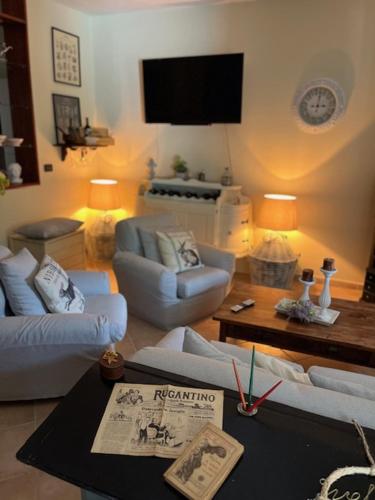 a living room with two couches and a tv at La Casina di Sandro in Nocera Umbra