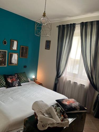 a bedroom with a large bed and a window at La Casina di Sandro in Nocera Umbra