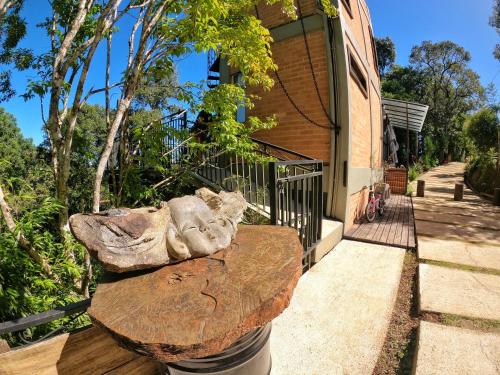 a stone bench in front of a building at Casa Container 80 in Campos do Jordão