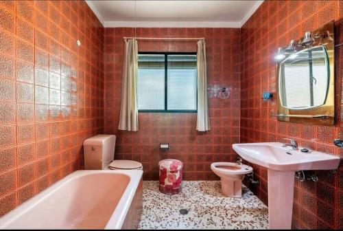 a bathroom with a tub and a toilet and a sink at La Solariega in Padul