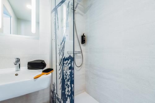 a bathroom with a shower and a sink at ibis Styles Ancenis Centre in Ancenis