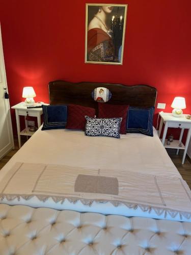 a bedroom with a large bed with red walls at La Casina di Sandro in Nocera Umbra