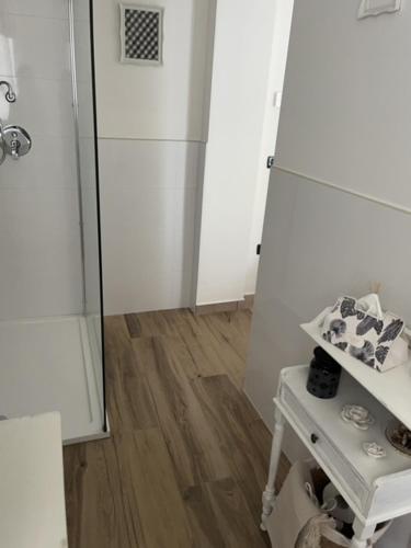 a kitchen with a white refrigerator and a table at La Casina di Sandro in Nocera Umbra