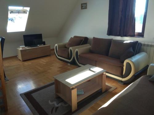 a living room with a couch and a coffee table at Apartman Malina in Zlatibor