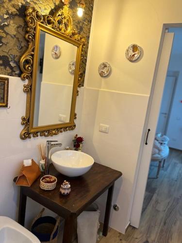 a bathroom with a sink and a mirror on the wall at La Casina di Sandro in Nocera Umbra