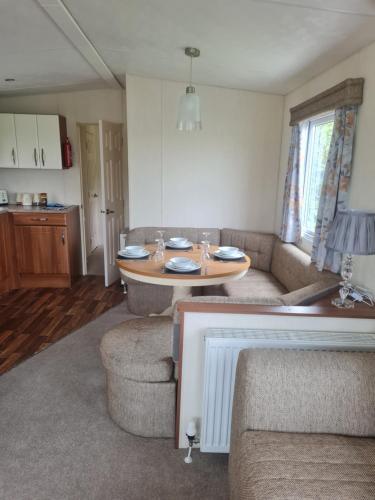 a living room with a couch and a table at Beautiful 3 bedroom holiday home Amazing views in Gisburn