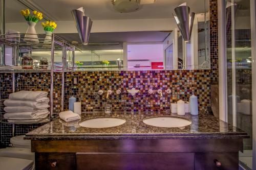 a bathroom with two sinks and a mirror at GABLES new 2024 in Bayside