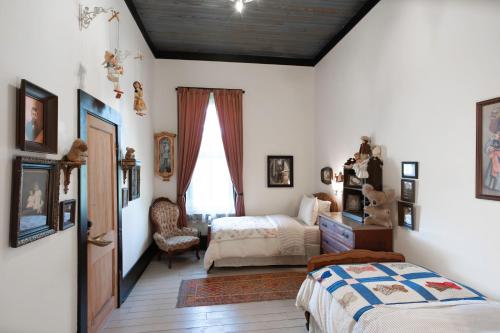 a bedroom with two beds and a window at Beard and Lady Inn in Chester