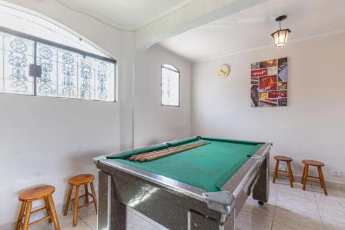 a room with a pool table and some stools at Casa espetacular com piscina para grupos - Glamour e lazer in São Paulo