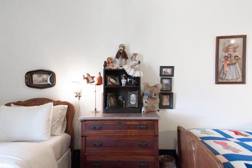 a bedroom with a wooden dresser next to a bed at Beard and Lady Inn in Chester