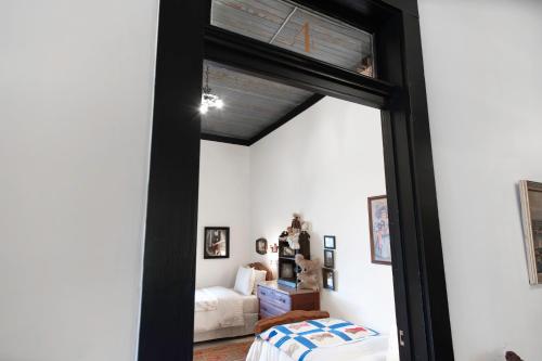 a room with a window and a bedroom with a bed at Beard and Lady Inn in Chester
