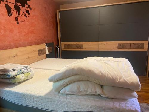 an unmade bed in a bedroom with a headboard at Ferienwohnung Regau 