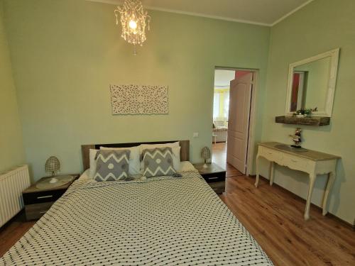 a bedroom with a bed and a chandelier at Boutigue city house with terrace and garden free parking in Rīga