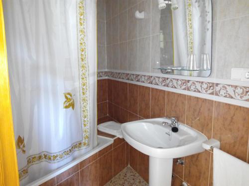 a bathroom with a sink and a mirror and a shower at Rincón De Pepe in El Castell de Guadalest