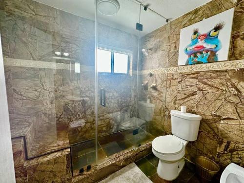 a bathroom with a toilet and a glass shower at *BEST House in MIAMI - Pool, Fashion, Central in Tamiami