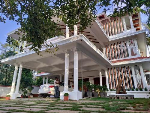 a woman standing in front of a house at The Cana's Coorg in Ammatti