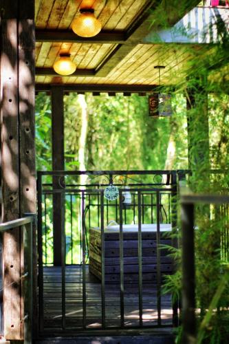 a screened in porch with a bench in the woods at Casa Container 80 in Campos do Jordão