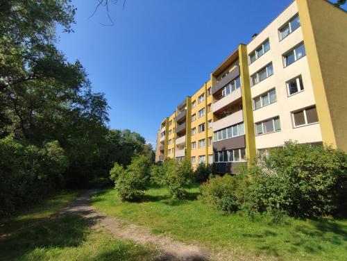 an apartment building with a yard in front of it at Sunset 26 in Liepāja
