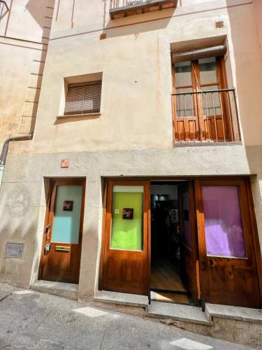 a building with wooden doors on the side of it at Felices Los Cuatro in Toledo