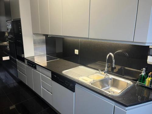 a kitchen with a sink and a counter top at Home of Neptune in Póvoa de Varzim