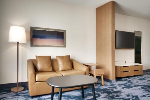 a living room with a couch and a table at Fairfield by Marriott Inn & Suites Houston League City in League City