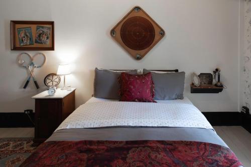a bedroom with a large bed with a wooden headboard at Beard and Lady Inn in Chester