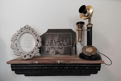 a table with a mirror and a lamp and a clock at Beard and Lady Inn in Chester