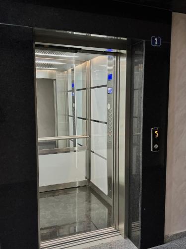 a glass elevator door in a building at Ultra Lux Apartment Free Underground Secure Parking in Pazardzhik