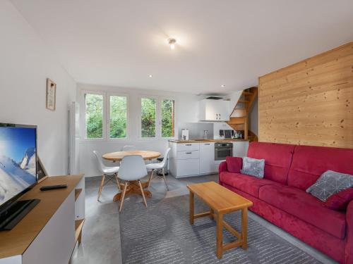 un salon avec un canapé rouge et une table dans l'établissement Appartement duplex cozy avec balcon et garage à Courchevel - FR-1-563-87, à Courchevel