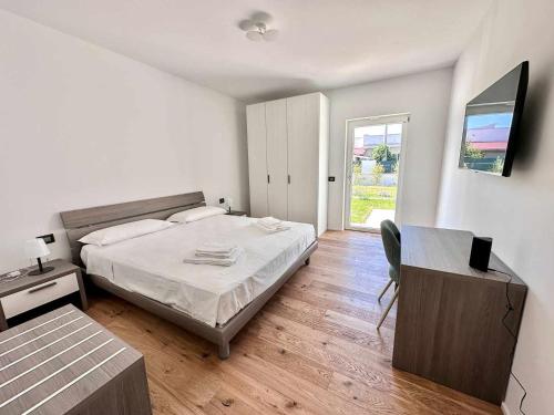 a bedroom with a bed and a desk and a window at Casa del Sol Luxury Estate Puglia in Leporano Marina